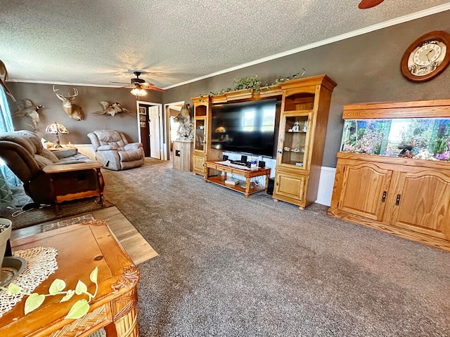 living room featuring a textured ceiling, carpet floors, ornamental molding, and ceiling fan