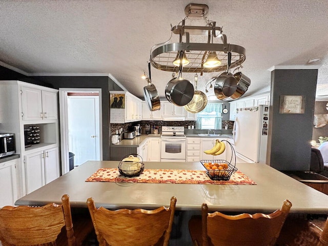 kitchen with sink, crown molding, white appliances, white cabinetry, and a textured ceiling