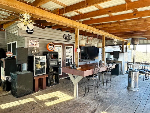 view of patio with exterior bar and a deck