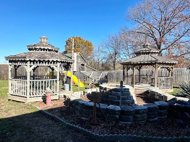 view of yard featuring a fire pit and a gazebo