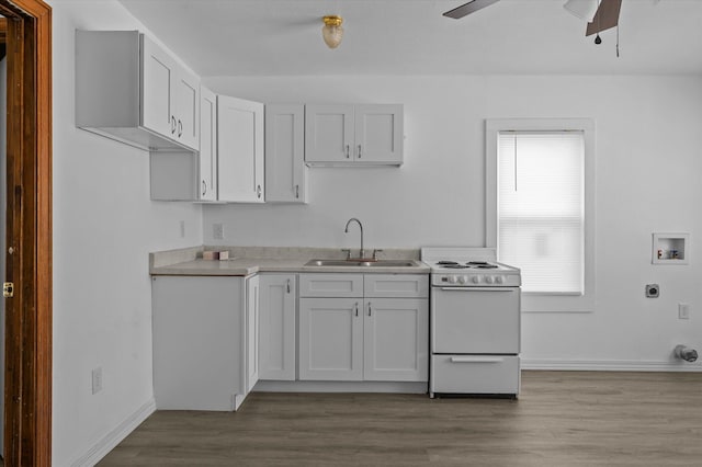 kitchen with light wood-type flooring, white range oven, ceiling fan, sink, and white cabinetry