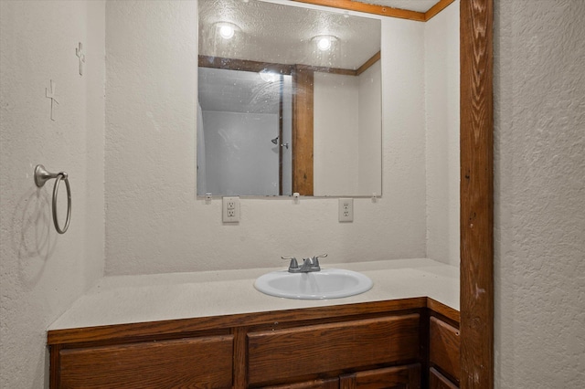 bathroom with vanity and ornamental molding