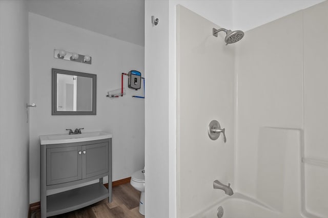 full bathroom featuring hardwood / wood-style floors, vanity, shower / bath combination, and toilet