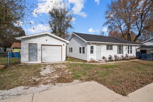 ranch-style home featuring a garage, an outdoor structure, and a front yard