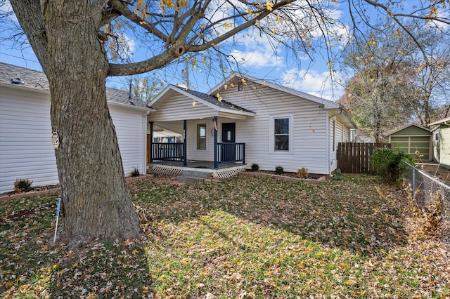 view of front of home featuring covered porch and a front yard