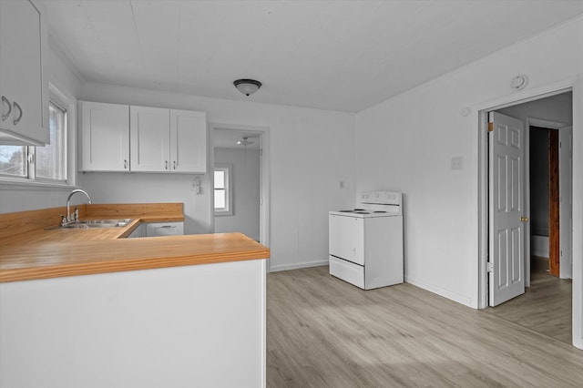 kitchen featuring white range with electric cooktop, white cabinetry, light wood-type flooring, and sink