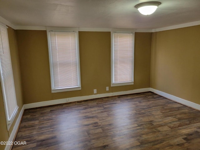 spare room with dark wood-type flooring