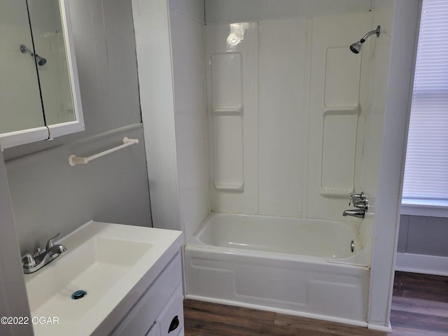 bathroom with vanity, hardwood / wood-style flooring, and shower / tub combination