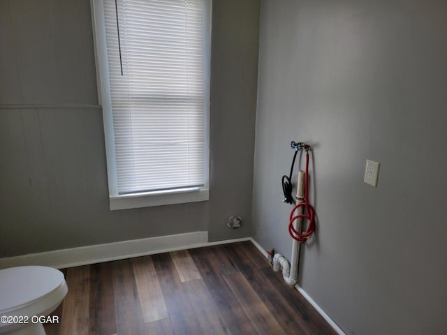 bathroom featuring wood-type flooring and toilet