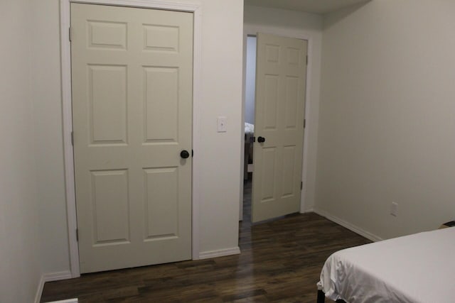 bedroom with dark wood-type flooring