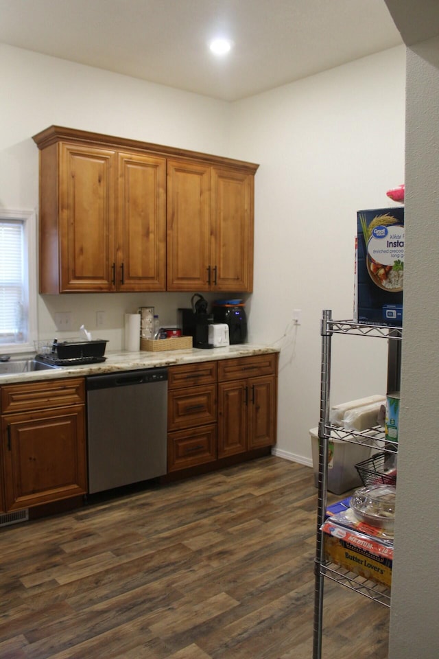 kitchen featuring stainless steel dishwasher and dark wood-type flooring