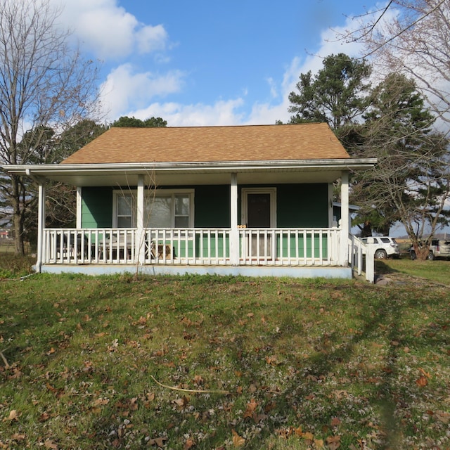 exterior space with covered porch and a lawn