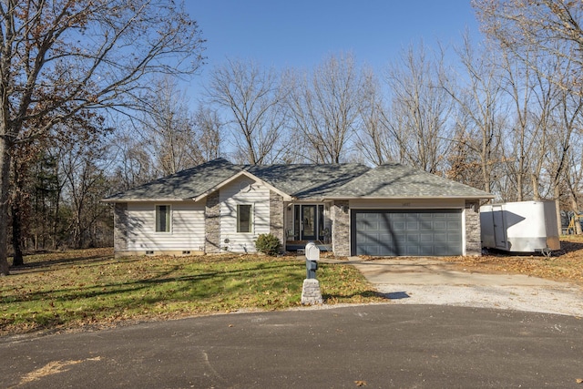 ranch-style house featuring a garage and a front yard