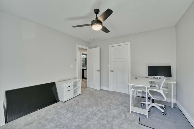 office featuring light carpet and ceiling fan