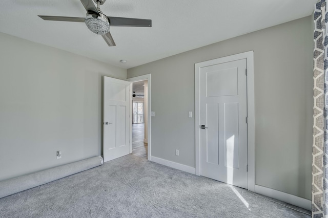 unfurnished bedroom with light carpet and ceiling fan