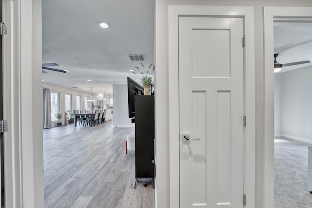 corridor with light wood-type flooring