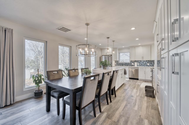 dining area featuring light wood-type flooring