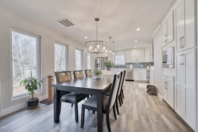 dining space with light hardwood / wood-style flooring