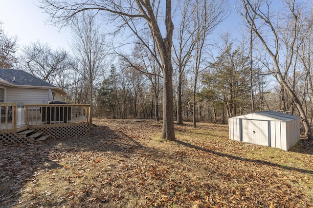 view of yard featuring a shed and a wooden deck