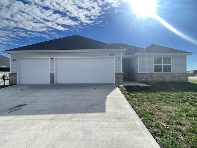 single story home with a garage and a front lawn