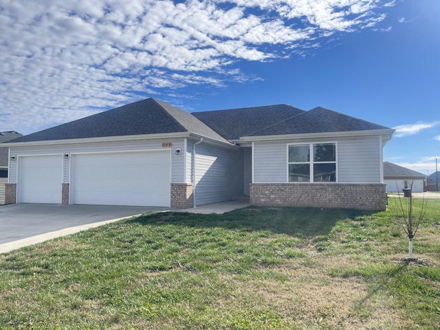 view of front of house with a front lawn and a garage