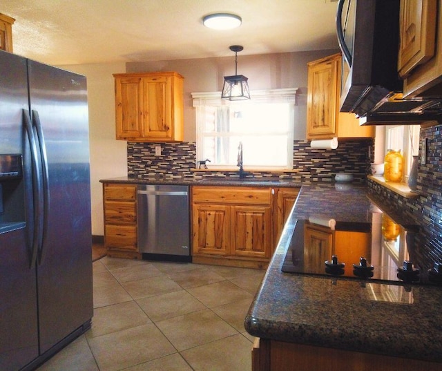 kitchen with decorative backsplash, appliances with stainless steel finishes, sink, pendant lighting, and light tile patterned flooring