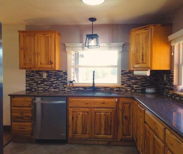 kitchen featuring dishwasher, backsplash, decorative light fixtures, and sink