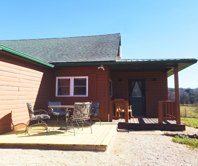 back of house featuring a wooden deck