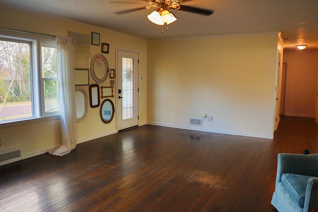 interior space with dark hardwood / wood-style flooring, ceiling fan, and ornamental molding