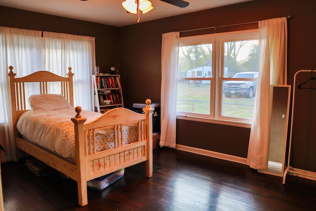 bedroom with ceiling fan and dark wood-type flooring