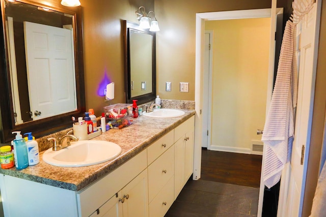 bathroom with hardwood / wood-style floors and vanity