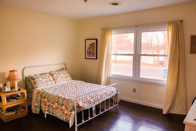 bedroom featuring dark hardwood / wood-style flooring