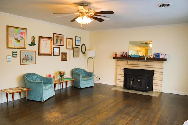 living room with dark hardwood / wood-style floors, ceiling fan, ornamental molding, and a fireplace