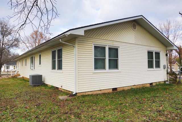 view of home's exterior with a lawn and cooling unit