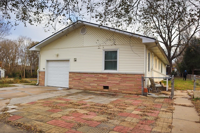 view of side of property with a garage