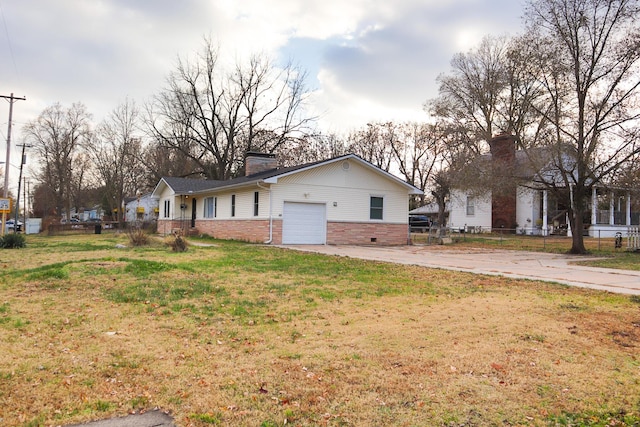 exterior space featuring a lawn and a garage