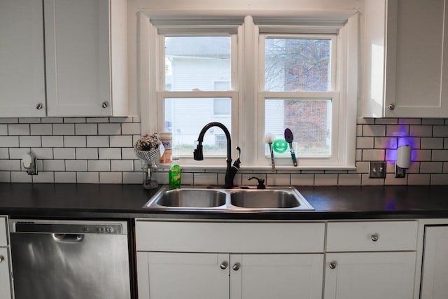 kitchen featuring tasteful backsplash, white cabinetry, dishwasher, and sink