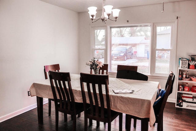 dining area with a chandelier and dark hardwood / wood-style floors