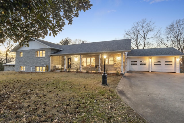 tri-level home featuring a garage and a yard