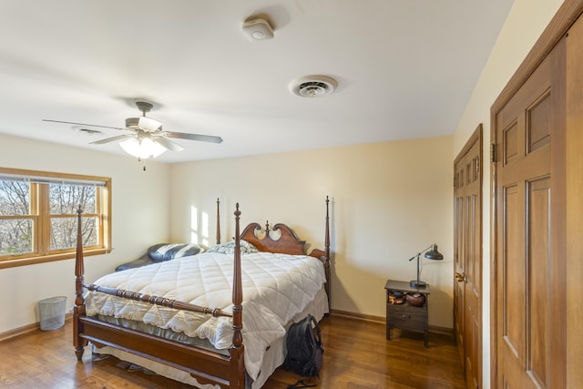 bedroom with dark hardwood / wood-style floors and ceiling fan