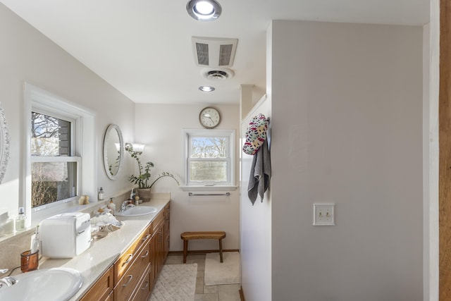 bathroom with tile patterned flooring and vanity