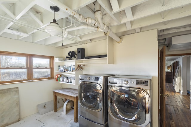 laundry room featuring hardwood / wood-style floors and washing machine and dryer