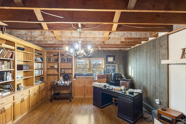 office with wood walls, beamed ceiling, a chandelier, and wood-type flooring