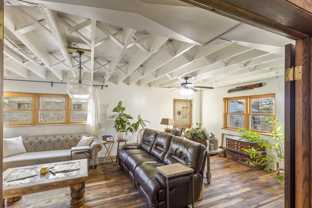 living room with vaulted ceiling with beams, ceiling fan, and dark wood-type flooring