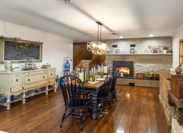 dining area with dark wood-type flooring and an inviting chandelier