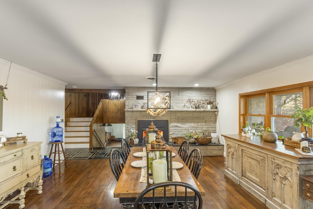 dining area with crown molding, wood walls, dark hardwood / wood-style floors, and an inviting chandelier