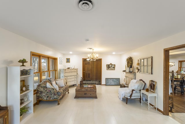 living room featuring an inviting chandelier and light hardwood / wood-style flooring