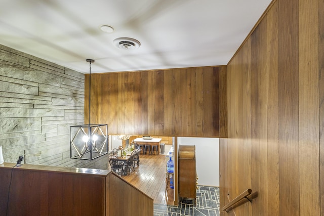 unfurnished office featuring wood walls and dark hardwood / wood-style flooring