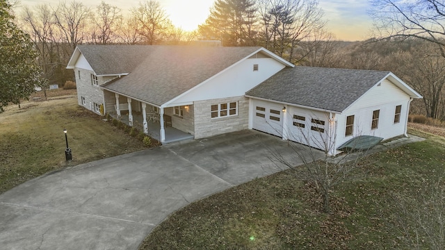 view of front of property with covered porch and a yard