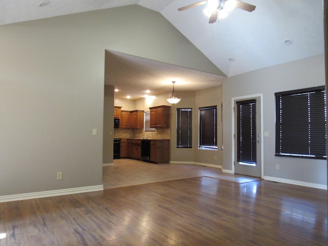 unfurnished living room with wood-type flooring, ceiling fan, and lofted ceiling